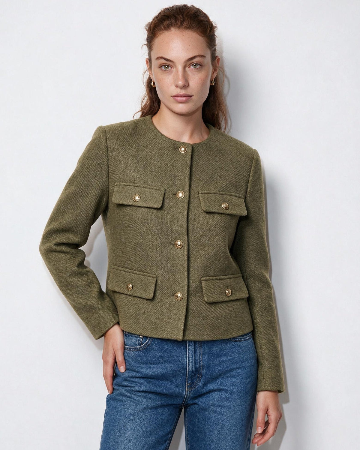 Olive green cropped collarless jacket with four flap pockets and gold buttons