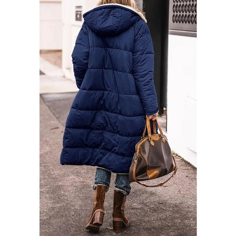 Dark blue longline puffer jacket with hood and tan sherpa lining on the inside