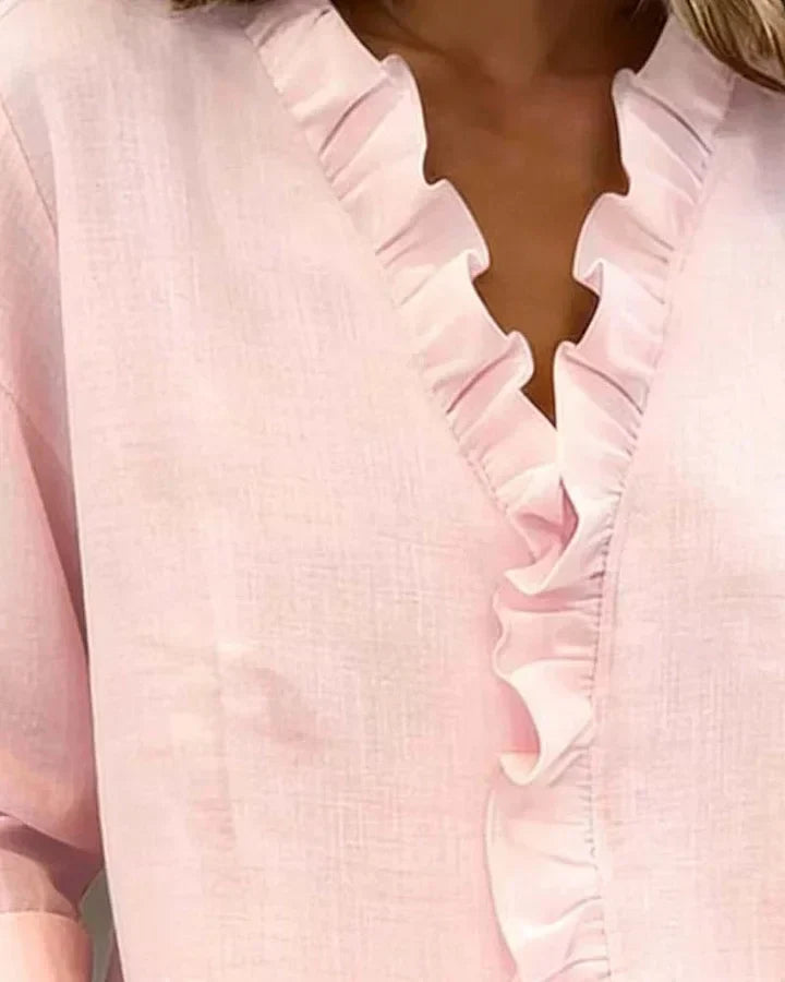 Light pink ruffle V-neck blouse with long sleeves