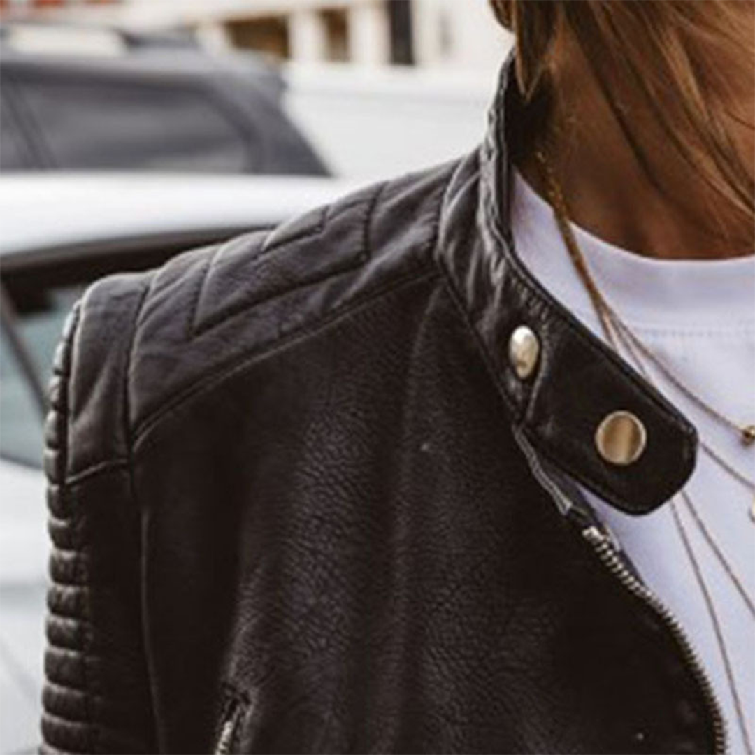 Black leather moto jacket shoulder strap detail with snap tab and asymmetrical zipper