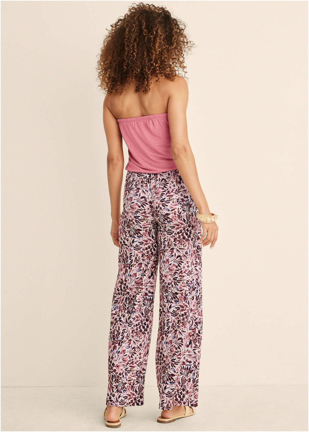 Back view strapless pink jumpsuit with abstract floral wide-leg legs