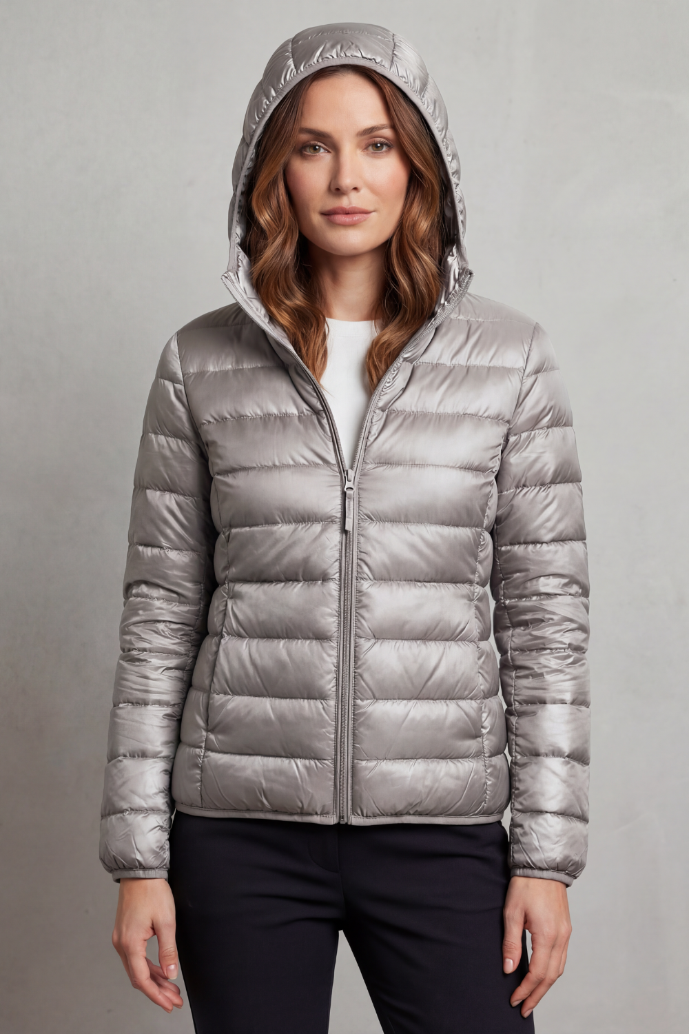 Women’s hooded puffer jacket in light grey, front view with full-zip and elastic cuffs.