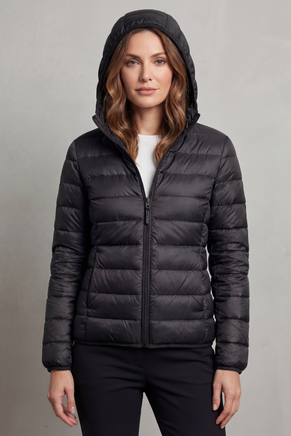 Women’s hooded puffer jacket in black, full-zip front and quilted insulation.