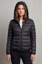 Women’s hooded puffer jacket in black, full-zip front and quilted insulation.