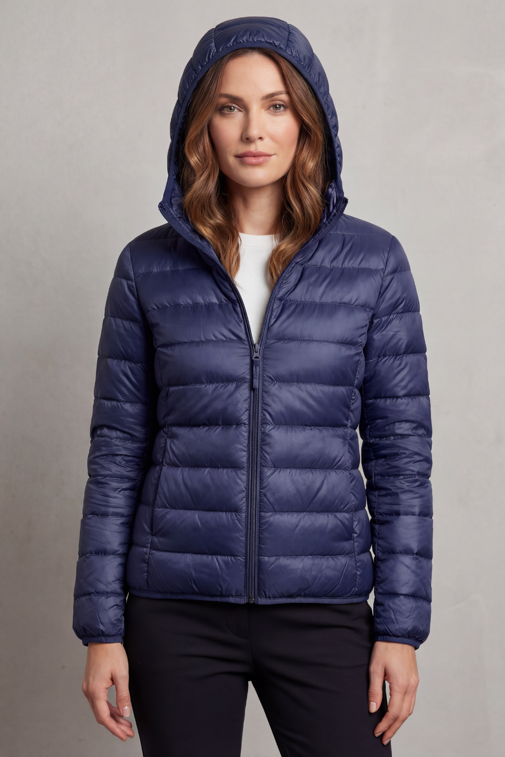 Women’s hooded puffer jacket in dark blue, full-zip front and quilted insulation.
