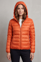 Women’s hooded puffer jacket in orange, full-zip front and quilted insulation.