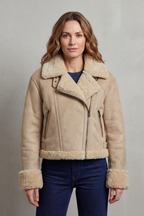 Beige cropped aviator jacket with tan fleece collar, hem, and cuffs; dual zipper pulls.