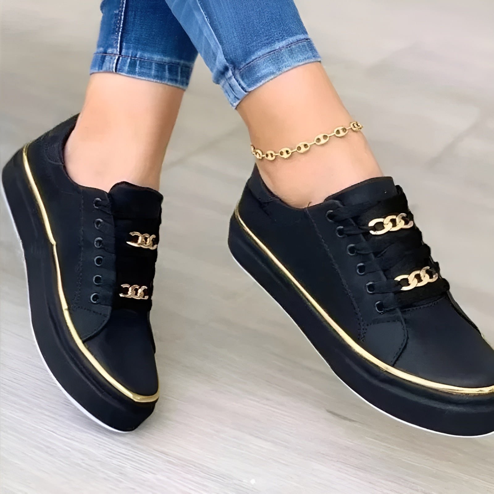 Dark navy women's orthopedic sneakers with gold trim, lace-up detail, and gold link ankle strap