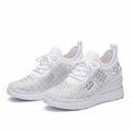 White knit orthopedic sneakers with lace-up front and thick white cushioned sole