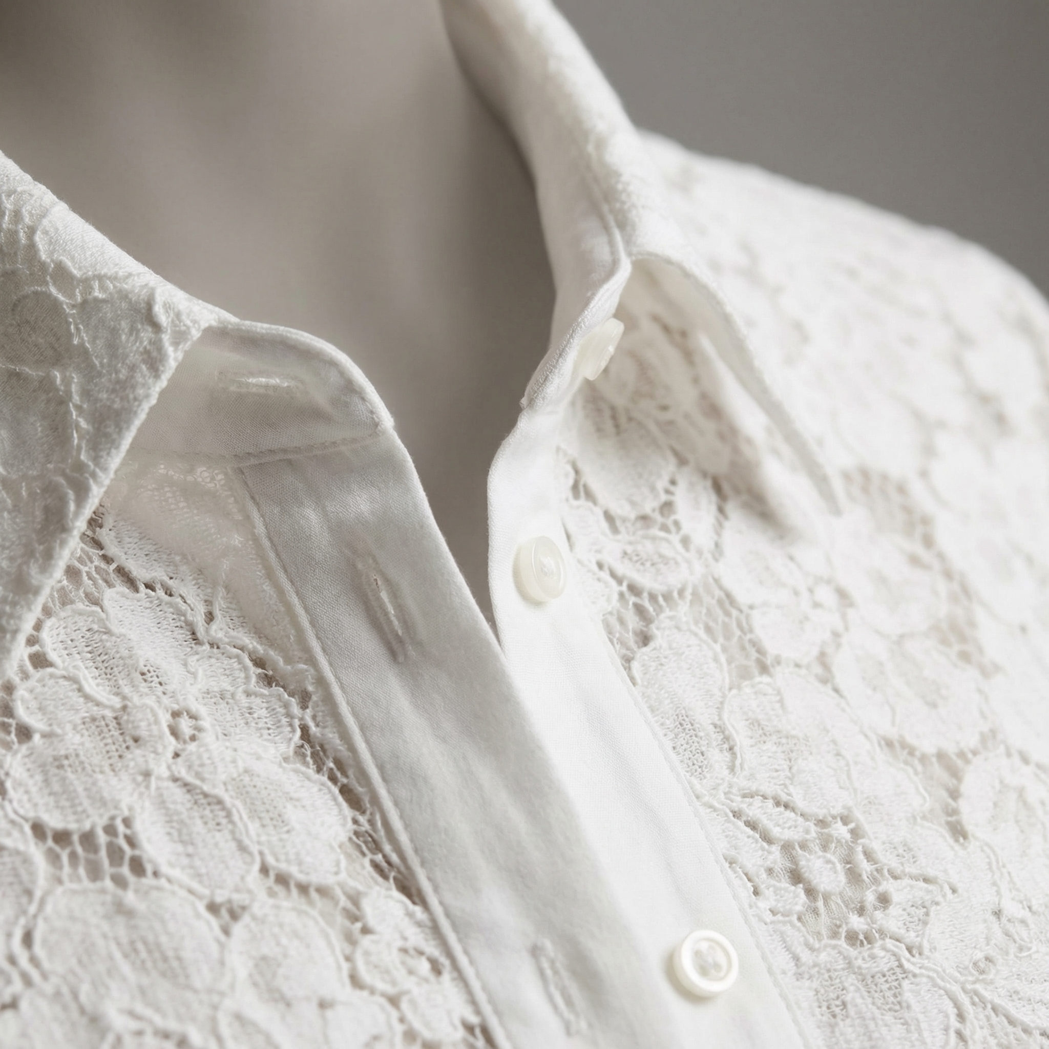 White lace blouse neckline close-up with pointed collar and two front buttons