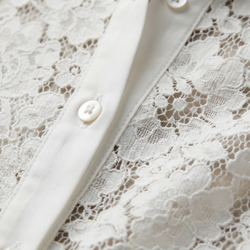 White lace blouse front close-up with hollow-out pattern and button placket