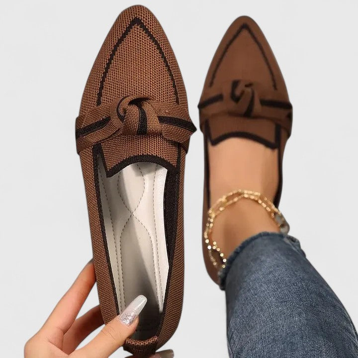 Women’s ribbon comfort sandals in brown with black trim, lace-up bow design.