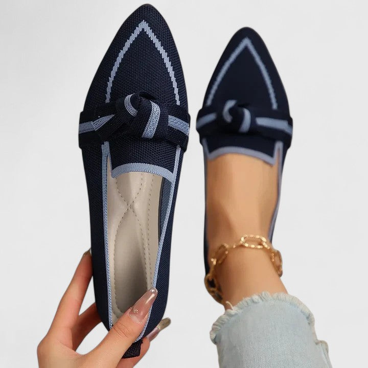 Women’s ribbon comfort sandals in navy with light trim, lace-up bow strap design.