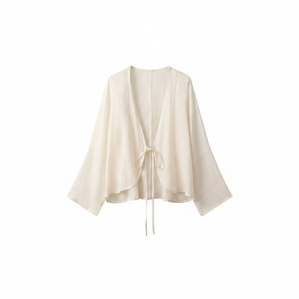 Cream cotton wrap top with V-neck and tied waist drawstring