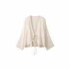 Cream cotton wrap top with V-neck and tied waist drawstring