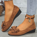 Brown suede ballerina flats with a layered bow at the toe