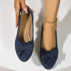 Blue suede ballerina flats with bow; one shows the inside lining