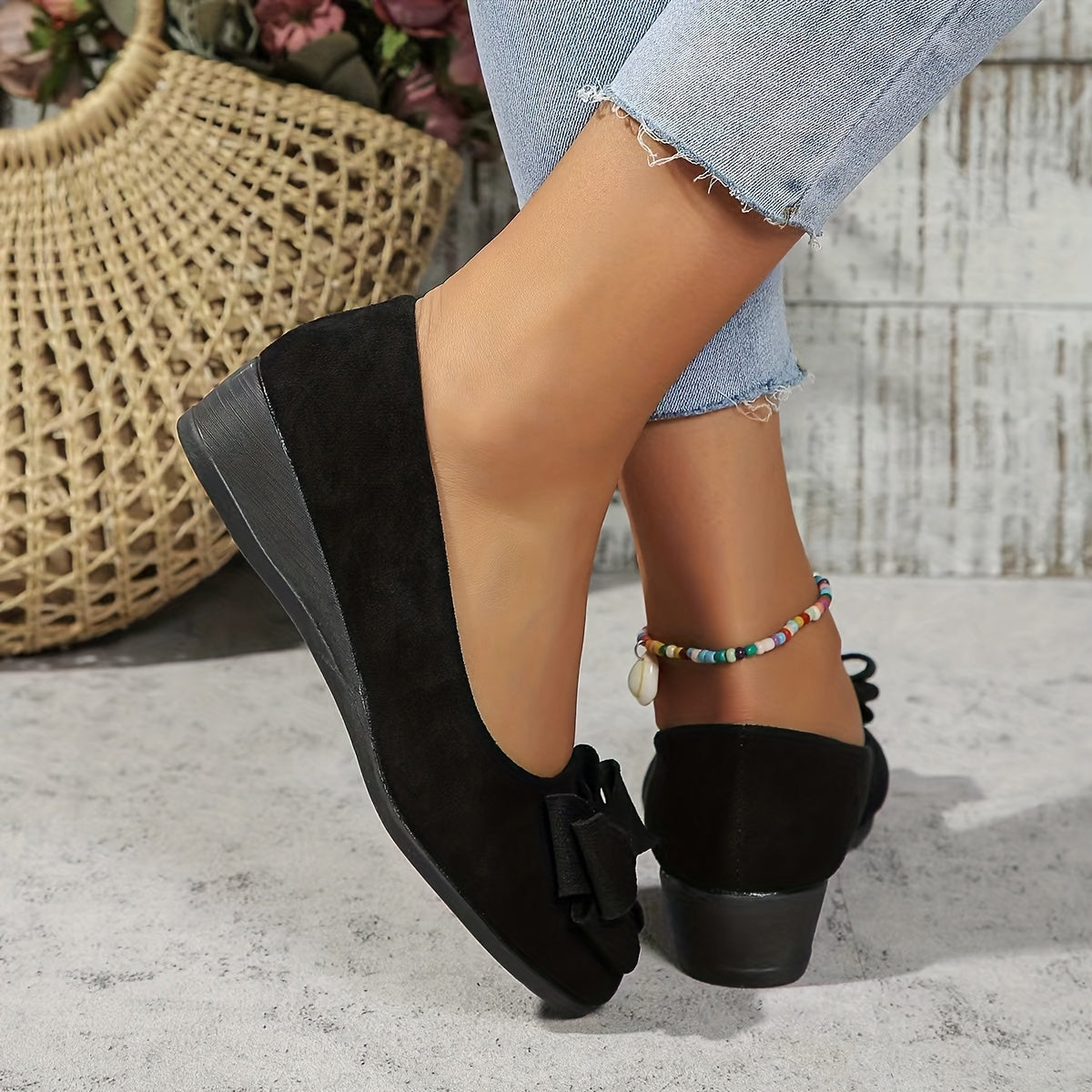 Black bow-back ballerina flats with a low stacked heel
