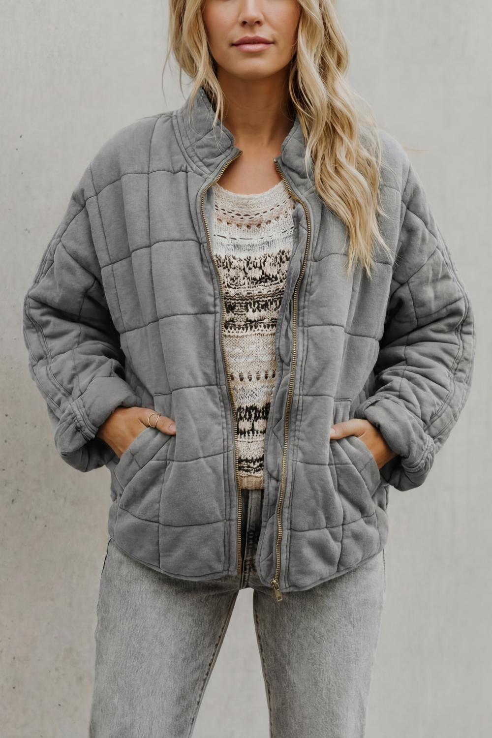 Quilted women’s zip-up jacket in medium grey, stand collar, long sleeves, front pockets