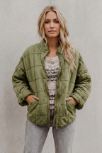 Sage green quilted women’s jacket with front zipper and stand collar.