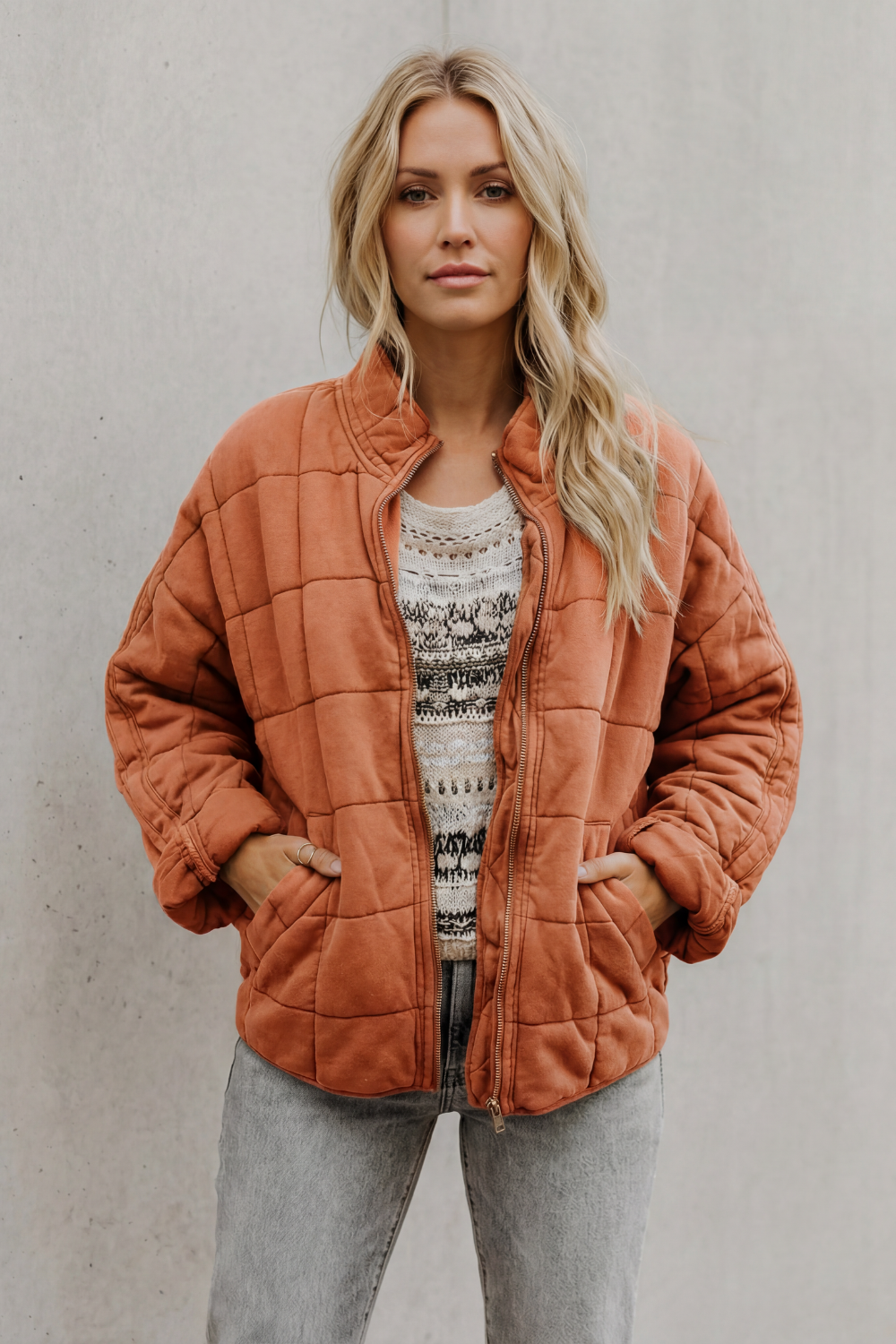 Quilted women’s zip-up jacket in rust orange, stand collar, long sleeves, pockets
