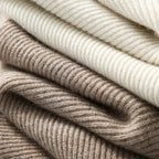 Ribbed knit layers of a women’s hoodie in cream and taupe tones