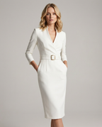 White belted midi dress with V-neck and fitted long sleeves.