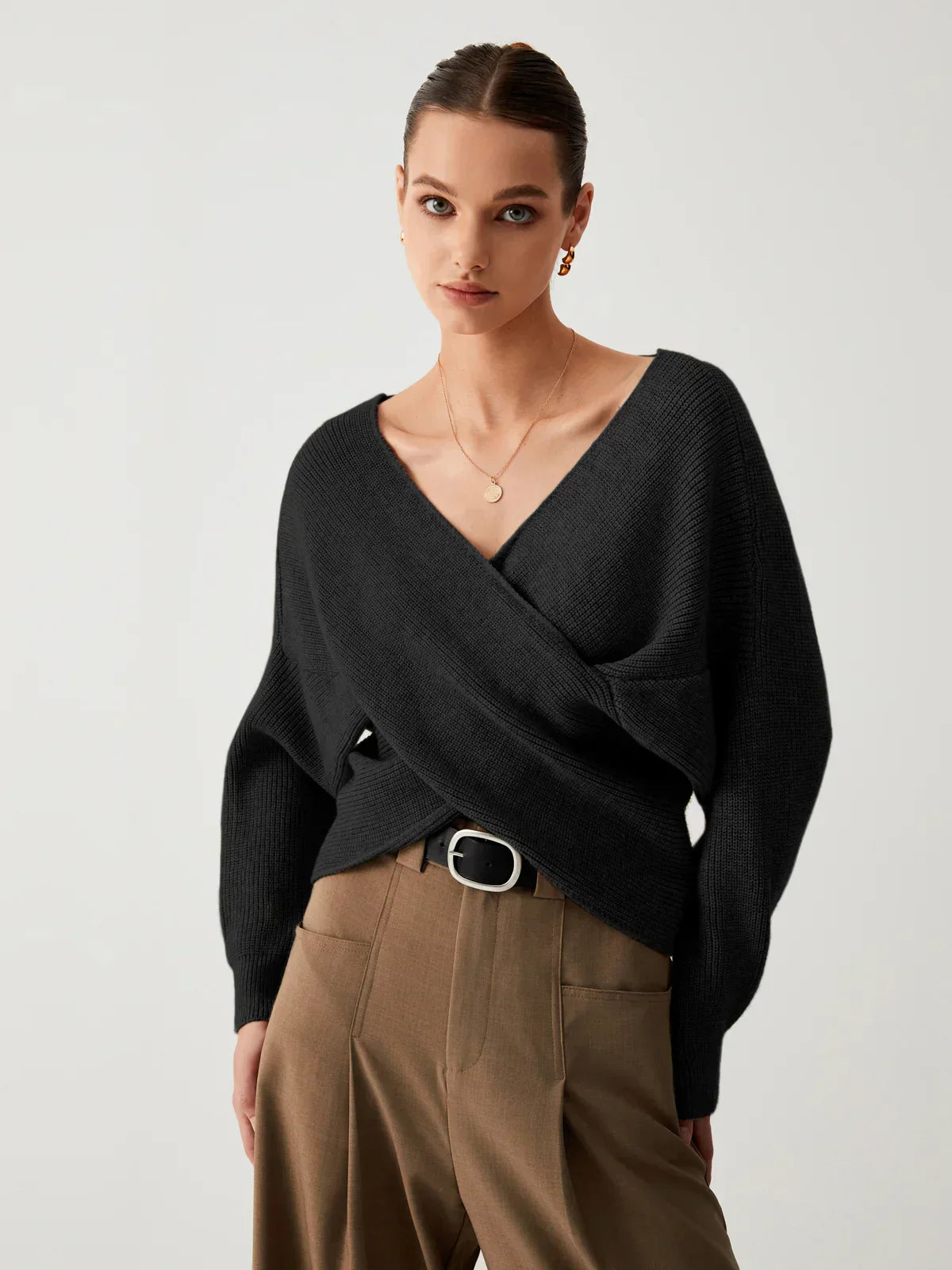 Black oversized V-neck knit sweater with long sleeves and crossover front