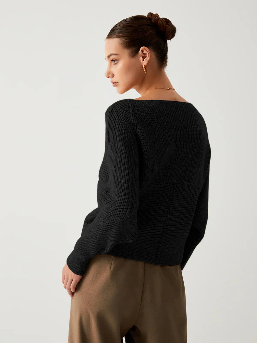 Black oversized V-neck knit sweater, back view, ribbed knit long sleeves
