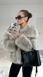 Oversized faux fur jacket in light gray with wide lapels and button front