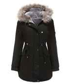 Women’s parka coat in black with faux fur trimmed hood, zip pocket, and snap buttons
