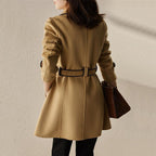 Beige wool coat with black-trim stand collar and belted waist, back/side view
