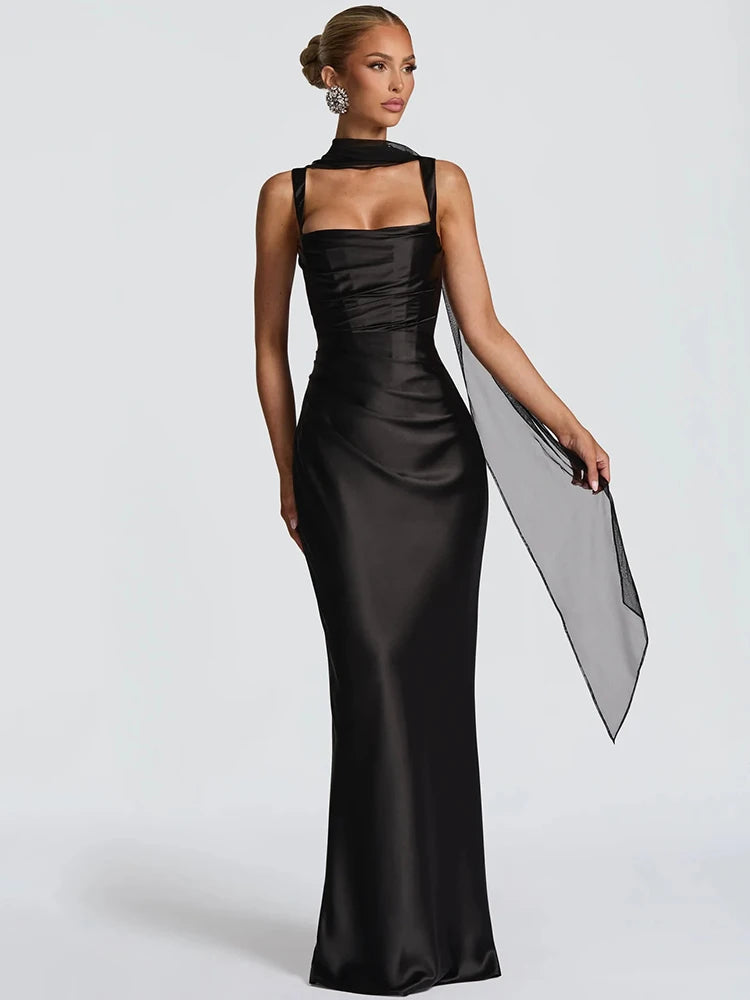 Black satin open-back halter maxi dress with square neckline and side drape panel