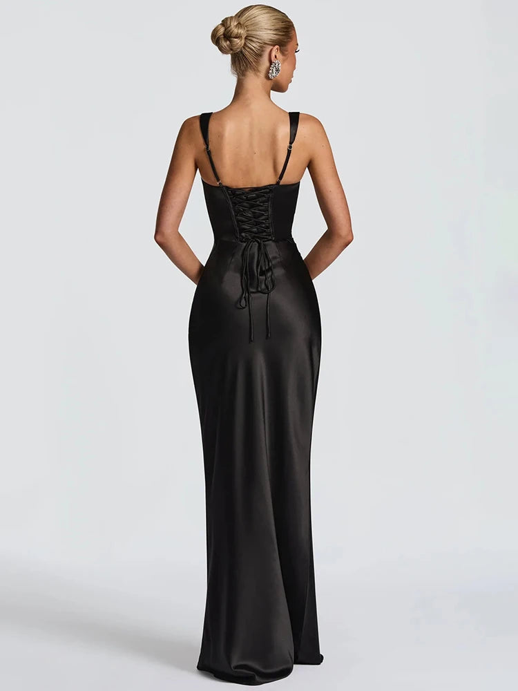 Black satin open-back maxi dress with thin halter straps and gathered back detail