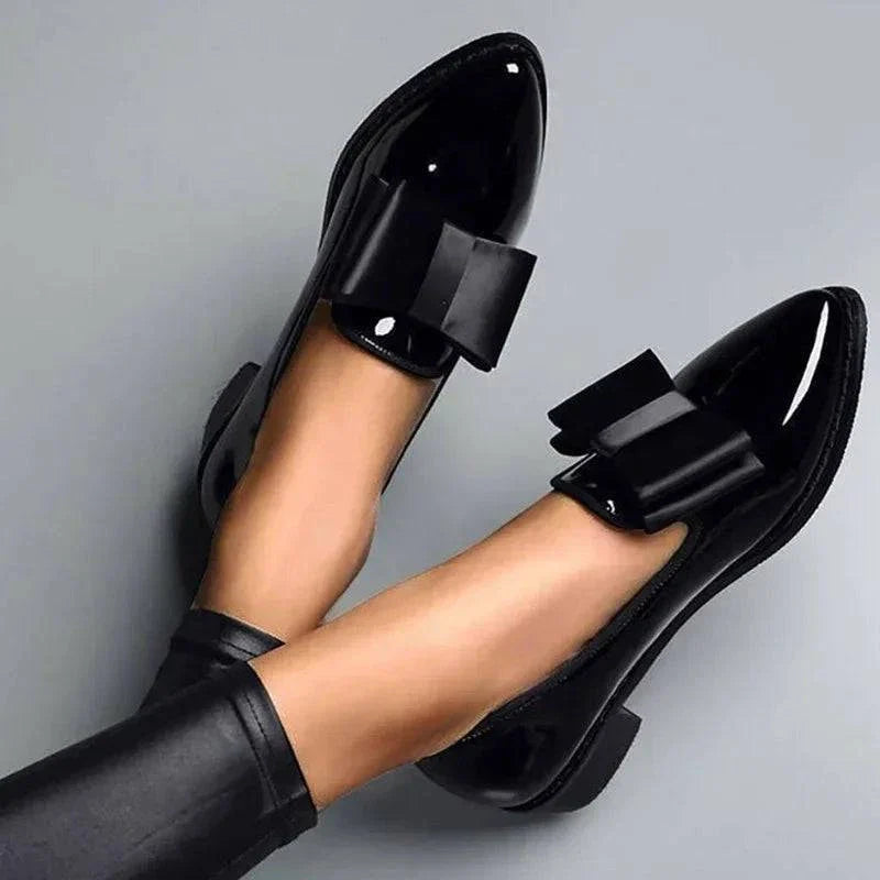 Black patent loafers with bow strap detail and low block heel