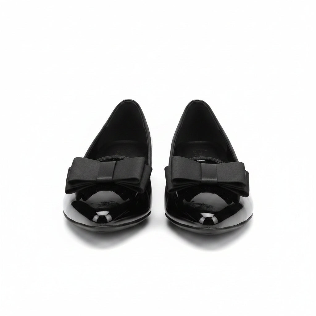 Black patent loafers with bow strap detail, pointed toe and low heel