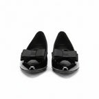 Black patent loafers with bow strap detail, pointed toe and low heel