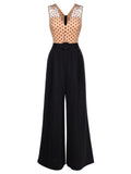 Black wide-leg jumpsuit with polka-dot V yoke and waist belt