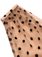 Beige sheer fabric patch with scattered black polka dots