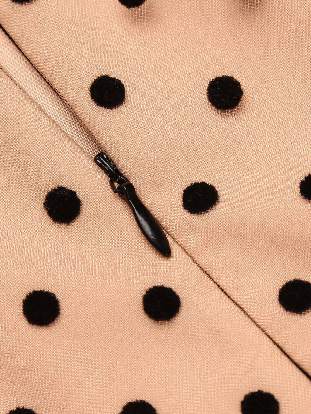 Beige polka-dot fabric with black teardrop zipper detail