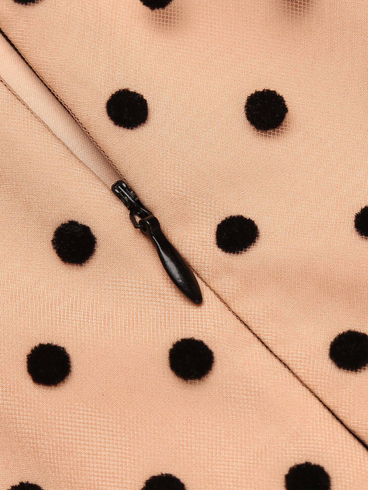 Beige polka-dot fabric with black teardrop zipper detail