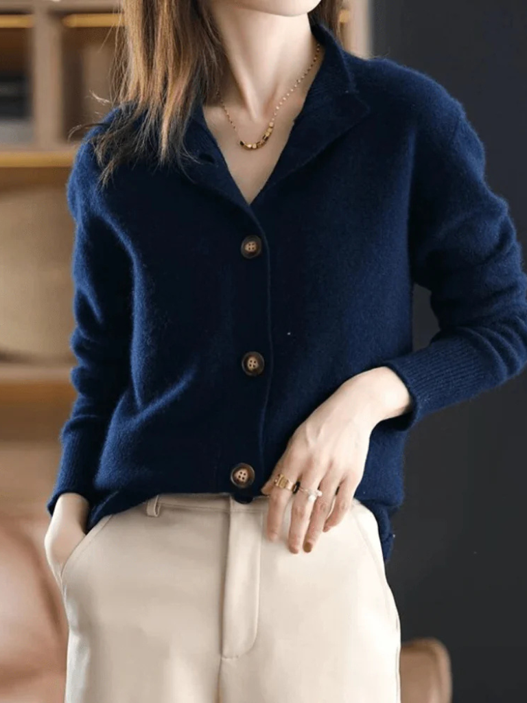 Navy blue knit button-front cardigan with pointed collar and wood-tone buttons