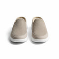 Beige indoor slip-on slippers with textured knit uppers and white rubber sole