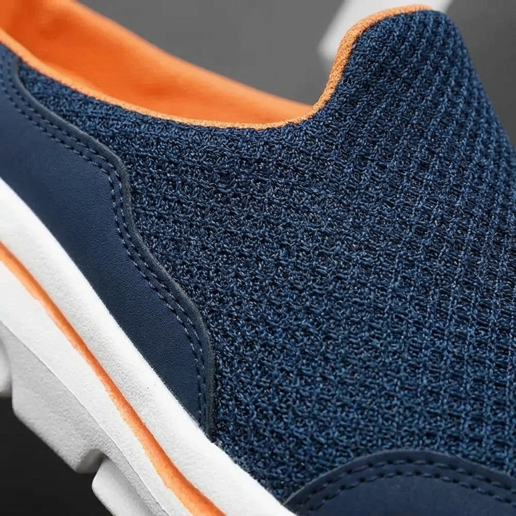 Close-up of navy blue indoor slipper knit upper with stitching and white sole edge