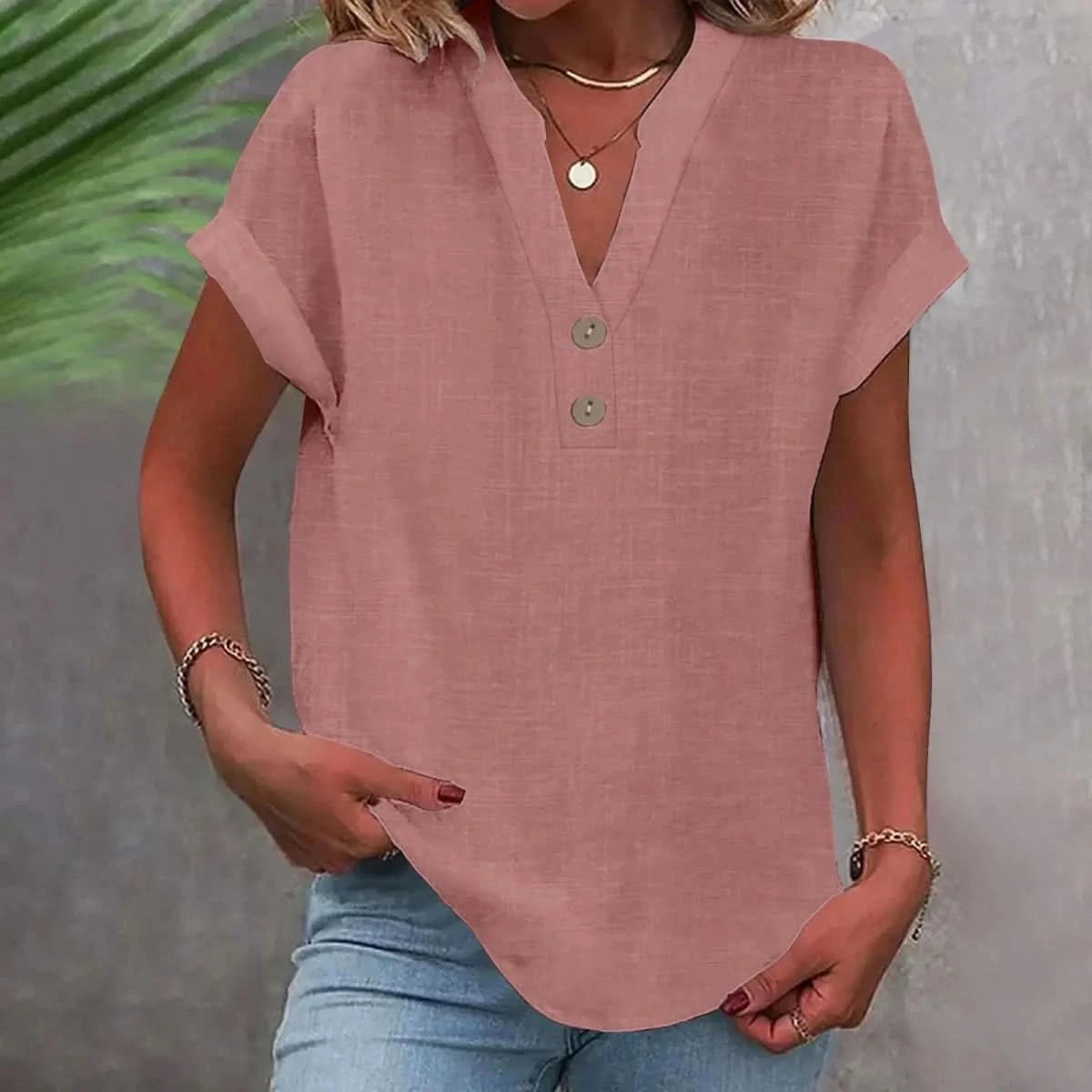 Pink linen V-neck top with short sleeves and button-front placket