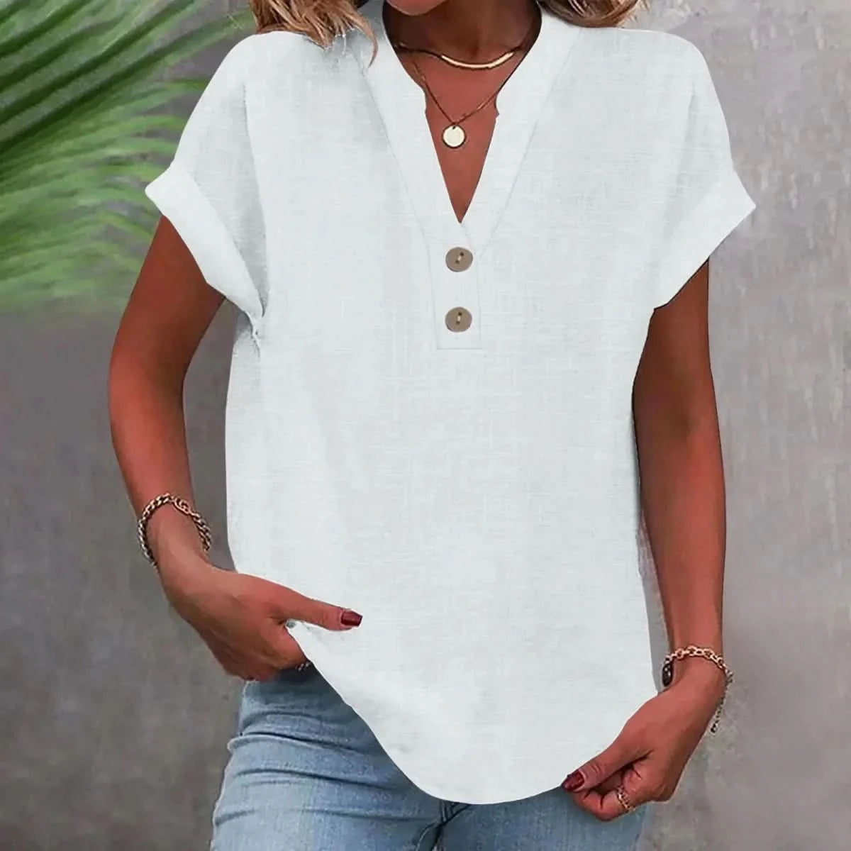 White linen V-neck top with short sleeves and button-front placket