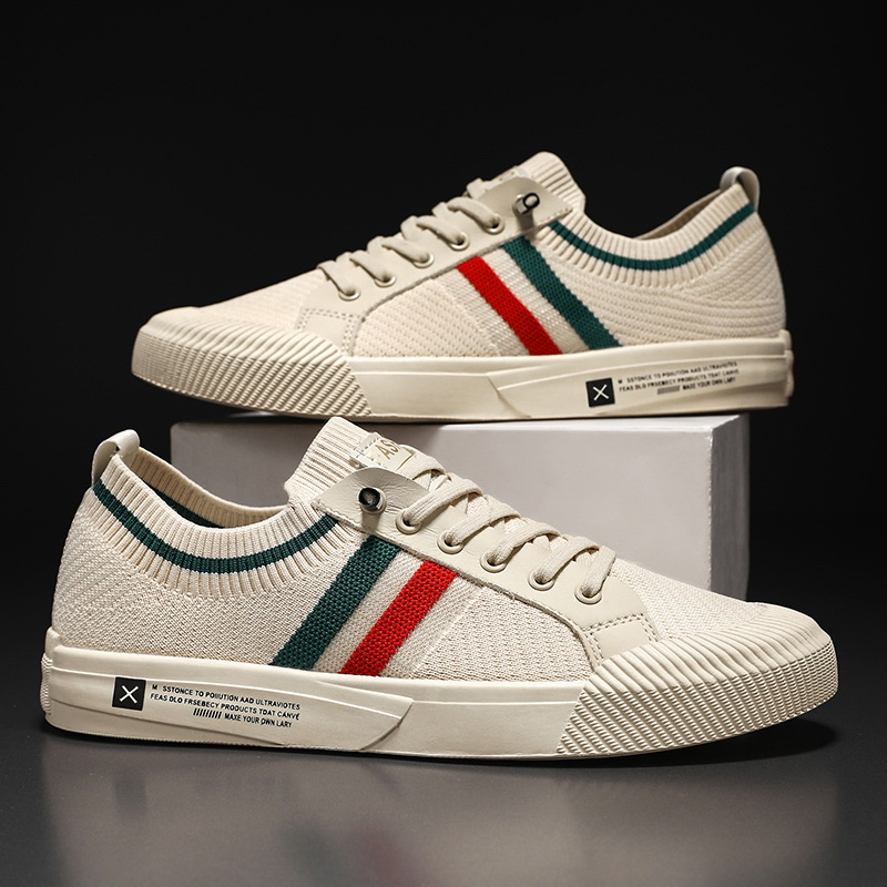 Pair of light sand low-top knit sneakers with red, green, and white side stripe