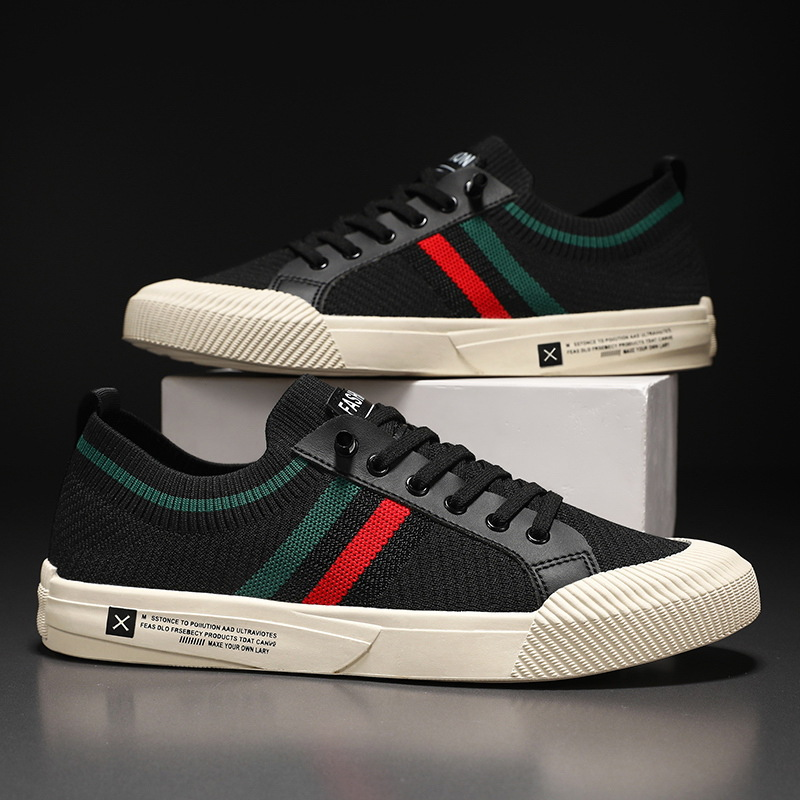 Pair of black low-top knit sneakers with multicolor side stripe and white sole