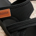 Black comfort sandals with textured upper and tan 'FASHION' label detail