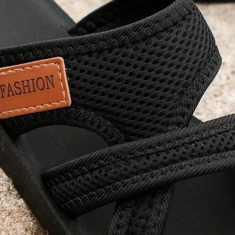 Black comfort sandals with textured upper and tan 'FASHION' label detail